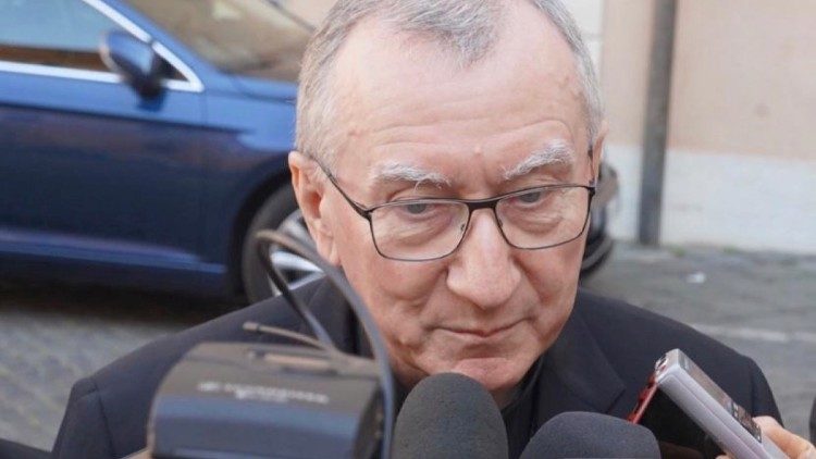 Cardinal Pietro Parolin speaks with reporters outside the Pontifical Gregorian University