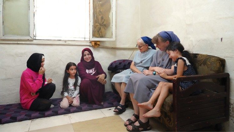 Sisters Magda and Cecilia visit a Syrian refugee family living at Dbayeh camp. Photo: Raghida Skaff - CNEWA