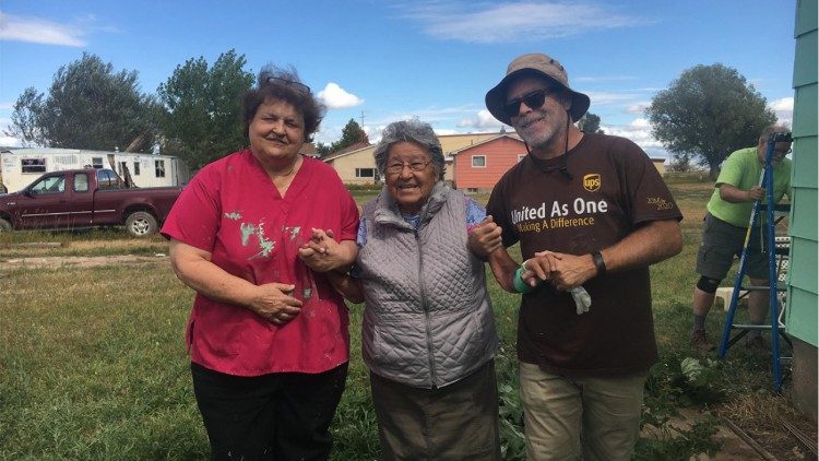  Sister Luke along with a volunteer share a heartfelt moment with an elderly local in Belize